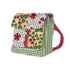 A fabric lunch bag with a green and white gingham pattern on the sides and base, a floral and strawberry print on the front flap, and a red polka-dot handle on a white background.