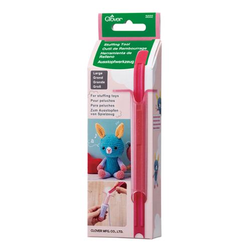 Pink stuffing tool with packaging on a white background