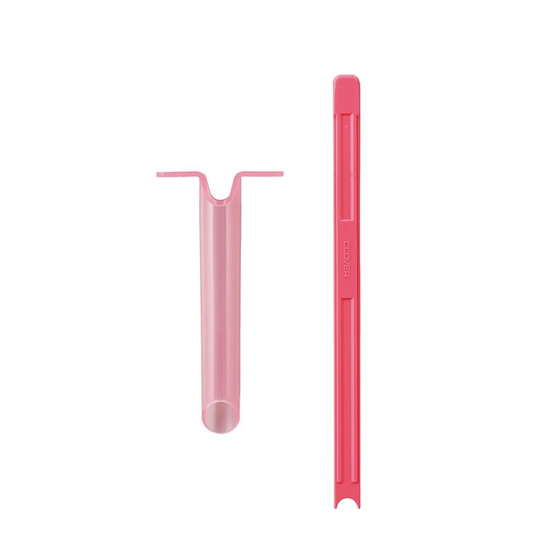 Pink plastic tool on a white background