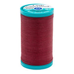Spool of red thread with a blue label on a white background
