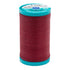 Spool of red thread with a blue label on a white background