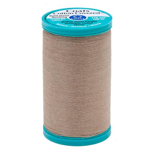 Spool of Coats Cotton Covered thread with teal cap on a white background