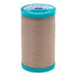 Spool of Coats Cotton Covered thread with teal cap on a white background