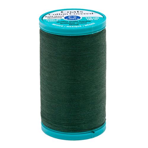 Spool of green thread with a Coats label on a white background