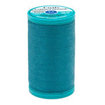 Spool of teal thread with Coats & Clark label on a white background