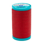 Red spool of thread with a blue label on a white background