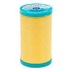 Spool of yellow thread with a blue lid on a white background