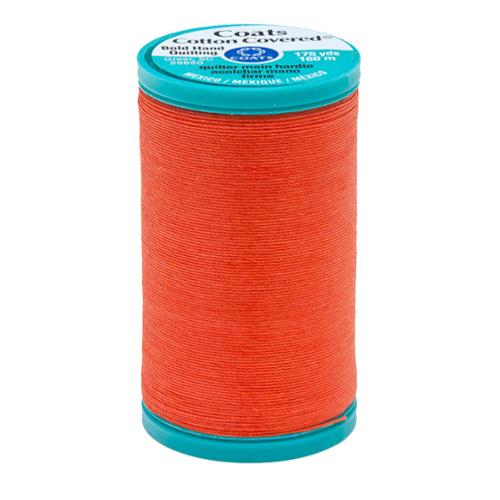 Spool of orange thread with a teal label on a white background