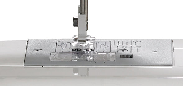 close up image of the Janome DC1050 Sewing Machine needle plate