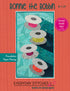 Quilt pattern cover titled 'Bonnie the Bobbin' with colorful spools of thread design on a red background.
