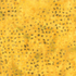 Yellow batik fabric with a scattered pattern of small green speckles.