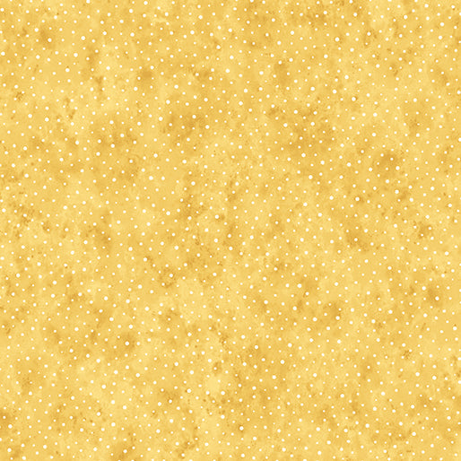 Yellow fabric with small white polka dots