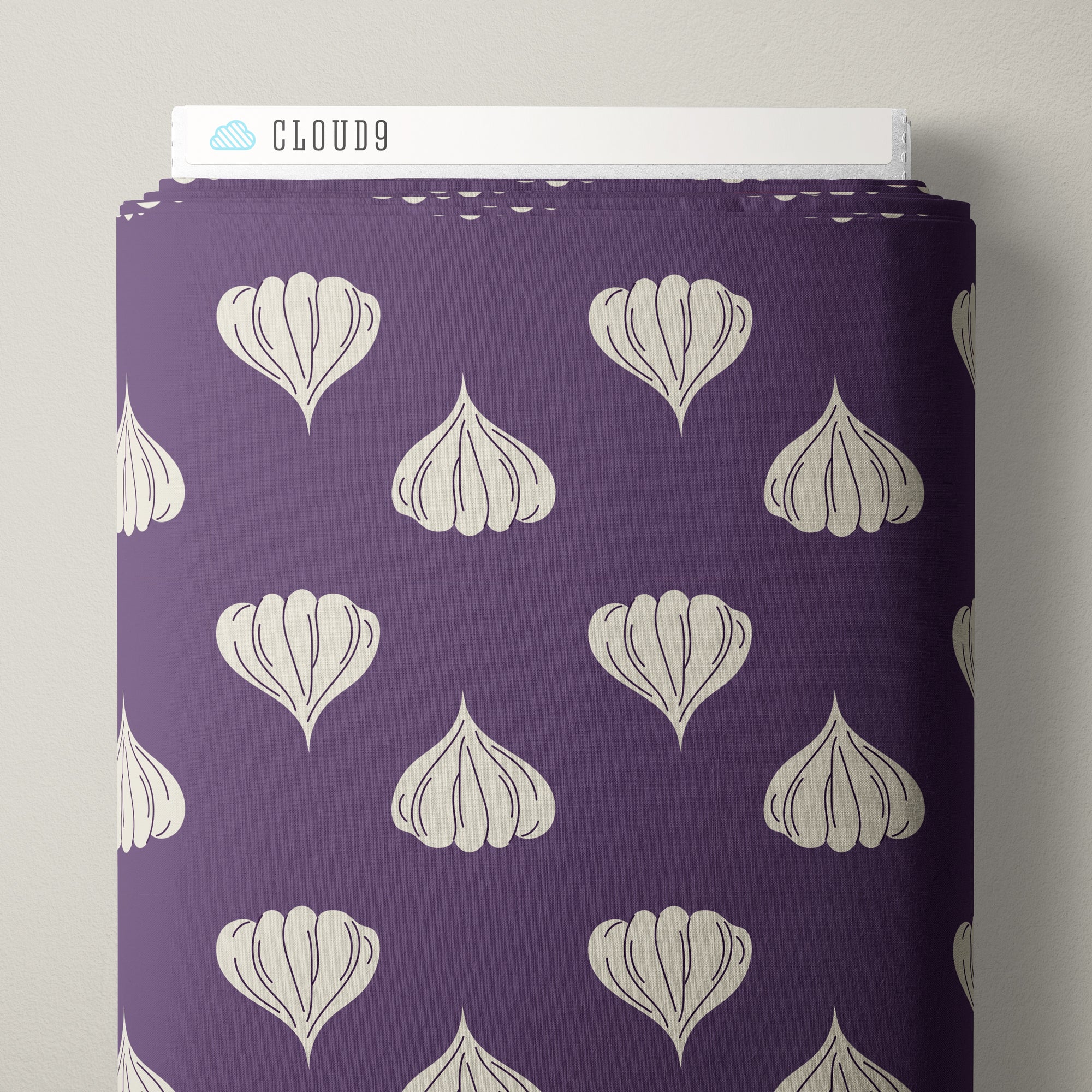 A roll of purple fabric featuring a repeating pattern of stylized garlic bulbs in off-white, shown standing upright with a white Cloud9 label visible at the top against a light gray background.