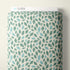 A roll of patterned fabric with a repeating leaf design in teal, mint, and light blue on an off-white background. A white label at the top reads CLOUD9.