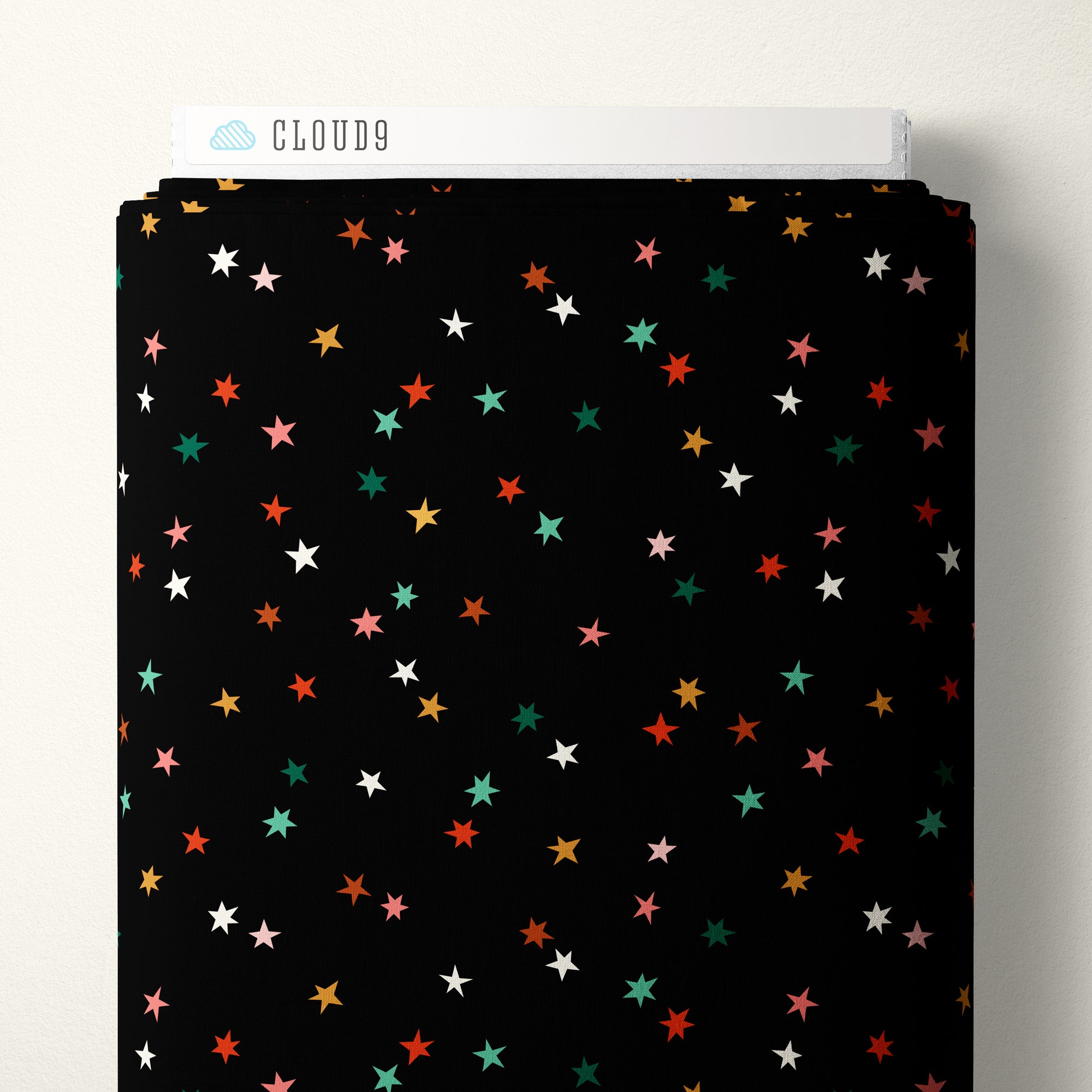 Black fabric with colorful star pattern on a white background