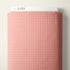 A close-up of a pink fabric with a repeating small cross pattern, shown with a white header card labeled CLOUD9 at the top against a light neutral background.