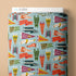 Fabric with colorful football-themed design on a beige background