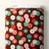 Fabric bolt with a colorful circular pattern on a burgundy background