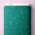Green fabric bolt with star pattern on a pink background