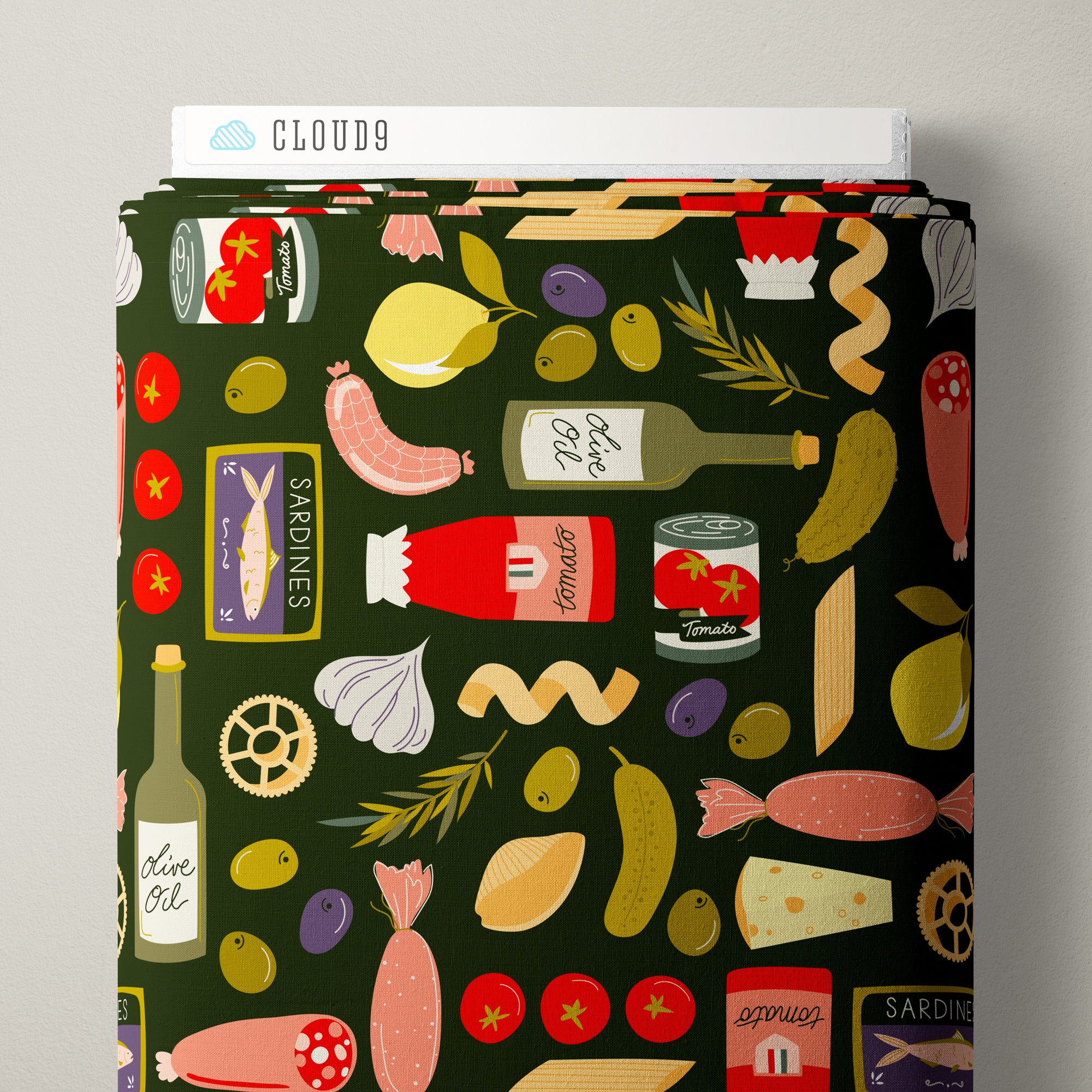A roll of fabric featuring a dark green background with a colorful, whimsical pattern of food items like tomatoes, olives, pasta, sausage, garlic, and bottles of olive oil and tomato sauce. The brand name 'CLOUD9' is visible on the cardboard spool at the top.