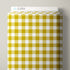 A roll of patterned fabric with a yellow and white gingham check design, shown on a neutral light gray background. A white header card at the top displays the brand name 'CLOUD9' with a small blue cloud logo.
