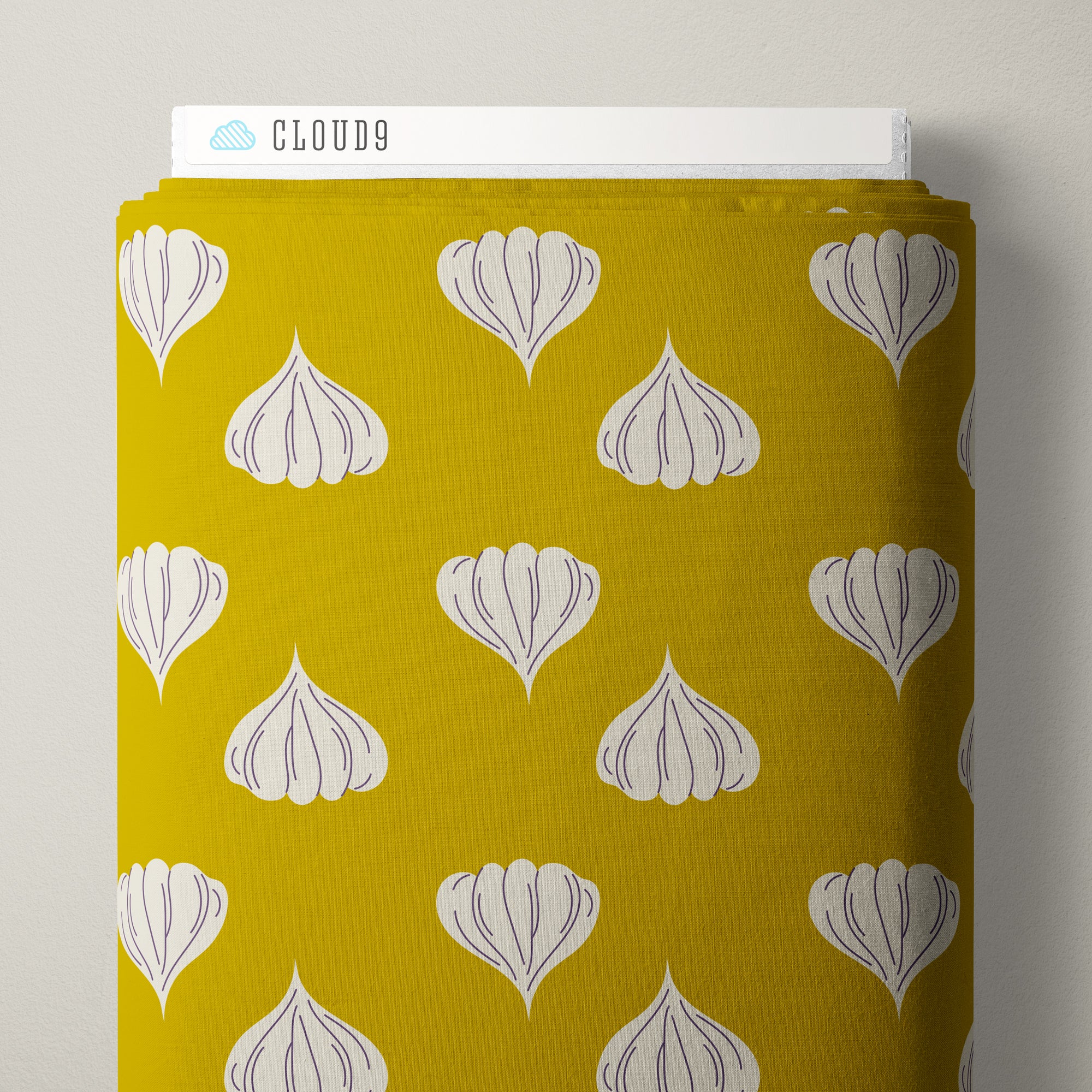 A roll of fabric with a mustard yellow background and a repeating pattern of white garlic bulb motifs, shown with the brand name CLOUD9 visible on the top edge.