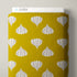 A roll of fabric with a mustard yellow background and a repeating pattern of white garlic bulb motifs, shown with the brand name CLOUD9 visible on the top edge.