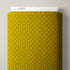 A close-up of a yellow fabric swatch with a repeating geometric pattern, with a white label reading CLOUD9 visible at the top against a light gray background.