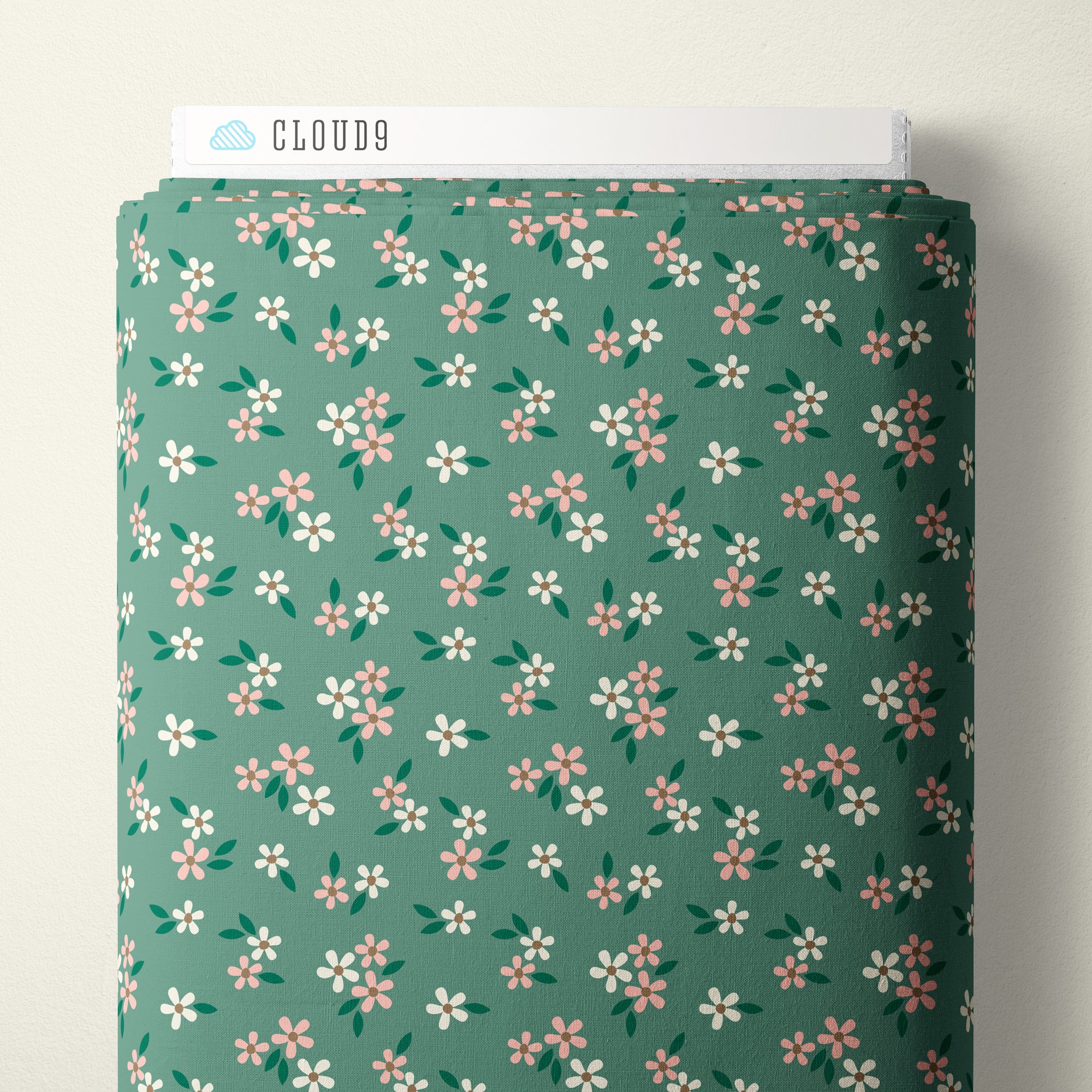 A roll of fabric with a sage green background and a repeating pattern of small white, pink, and green flowers, shown with a white label at the top that reads CLOUD9.