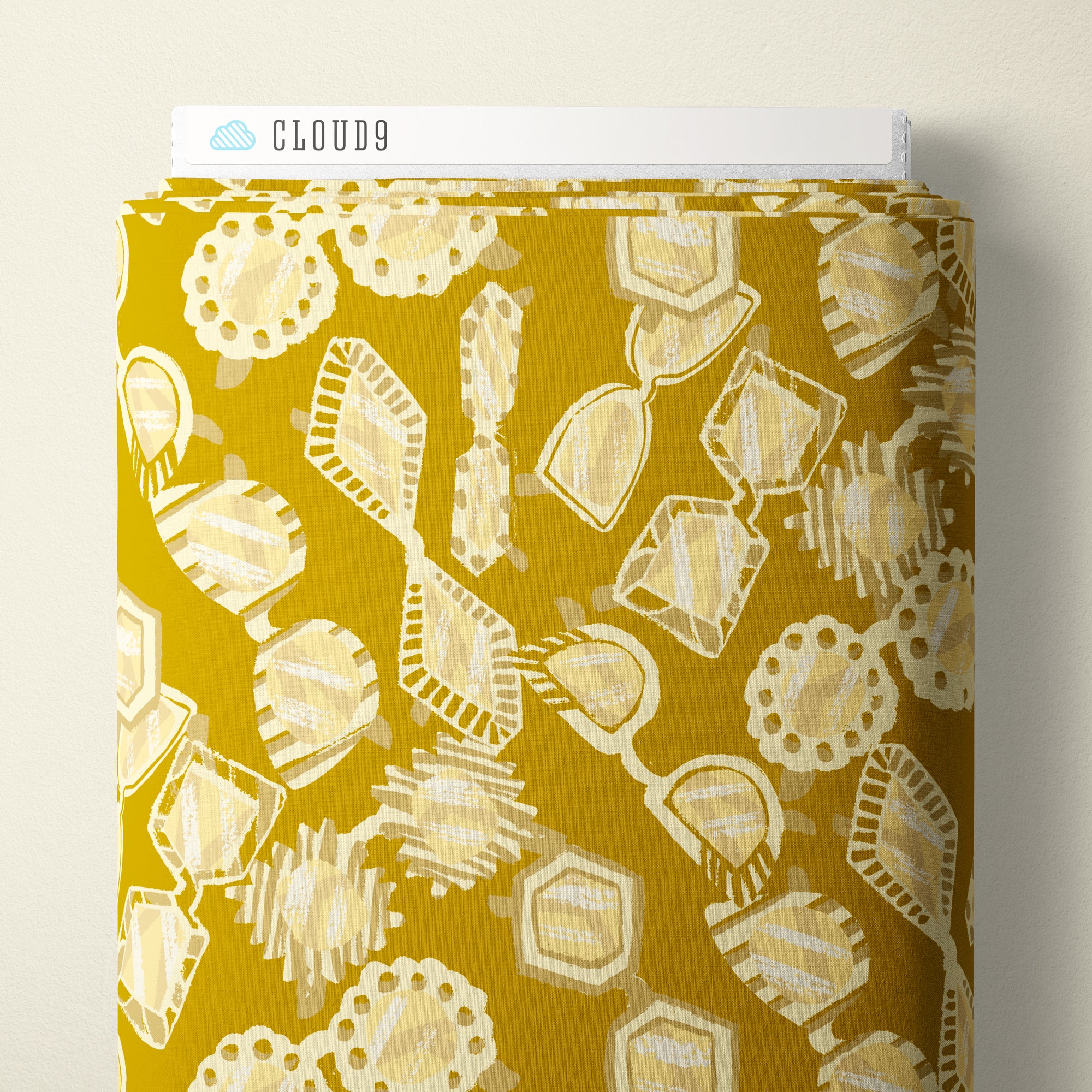 A roll of patterned fabric with a mustard yellow background and cream abstract geometric motifs, shown with a white header card labeled CLOUD9.