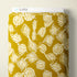 A roll of patterned fabric with a mustard yellow background and cream abstract geometric motifs, shown with a white header card labeled CLOUD9.