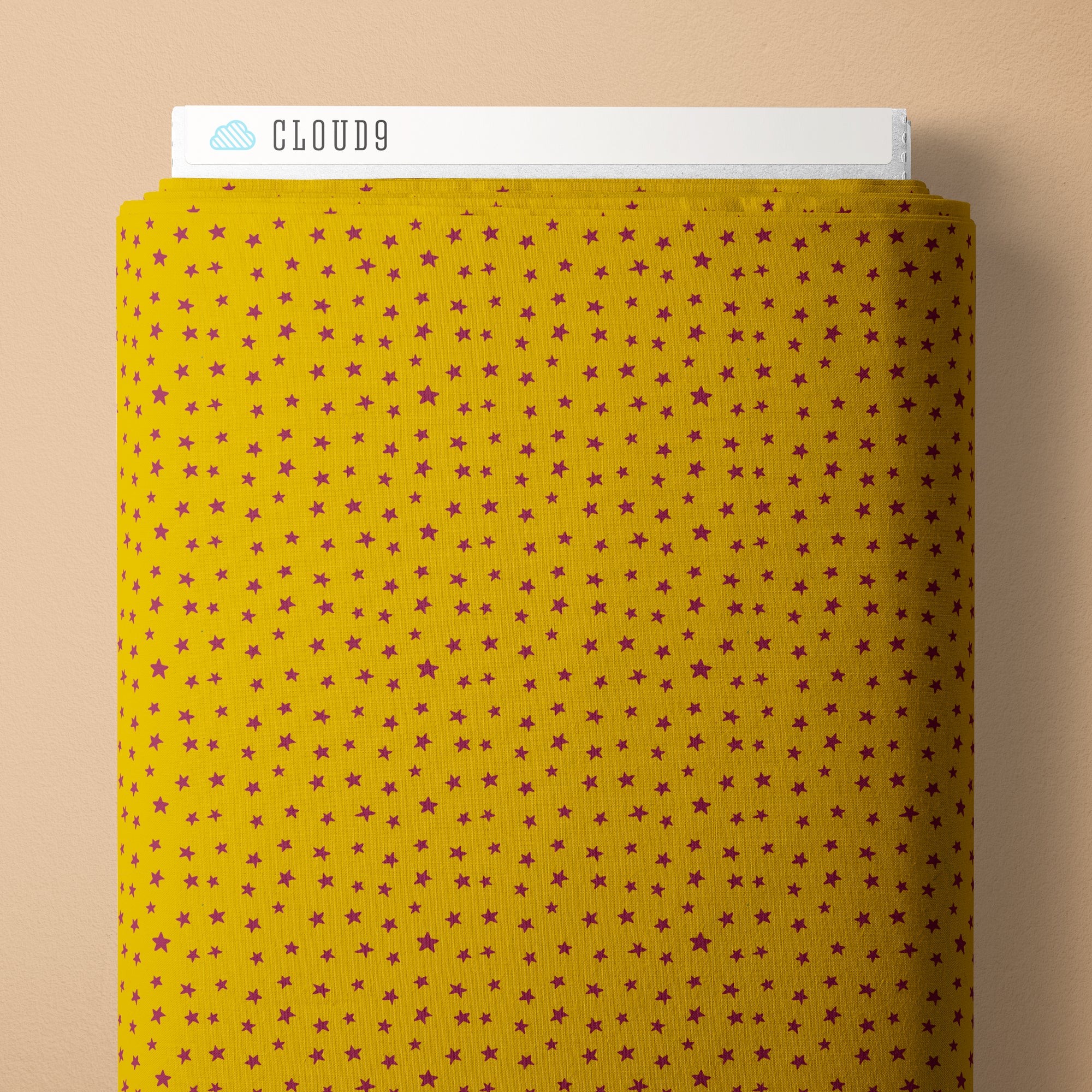 Mustard yellow fabric with star pattern and 'Cloud9' branding on a beige background
