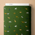 Green fabric with small dog pattern and Cloud9 branding on a beige background