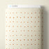 A roll of cream-colored fabric with a small, evenly spaced pattern of rust-brown diamond and square motifs, shown against a neutral beige background. A white header card at the top displays the brand name 'CLOUD9'.
