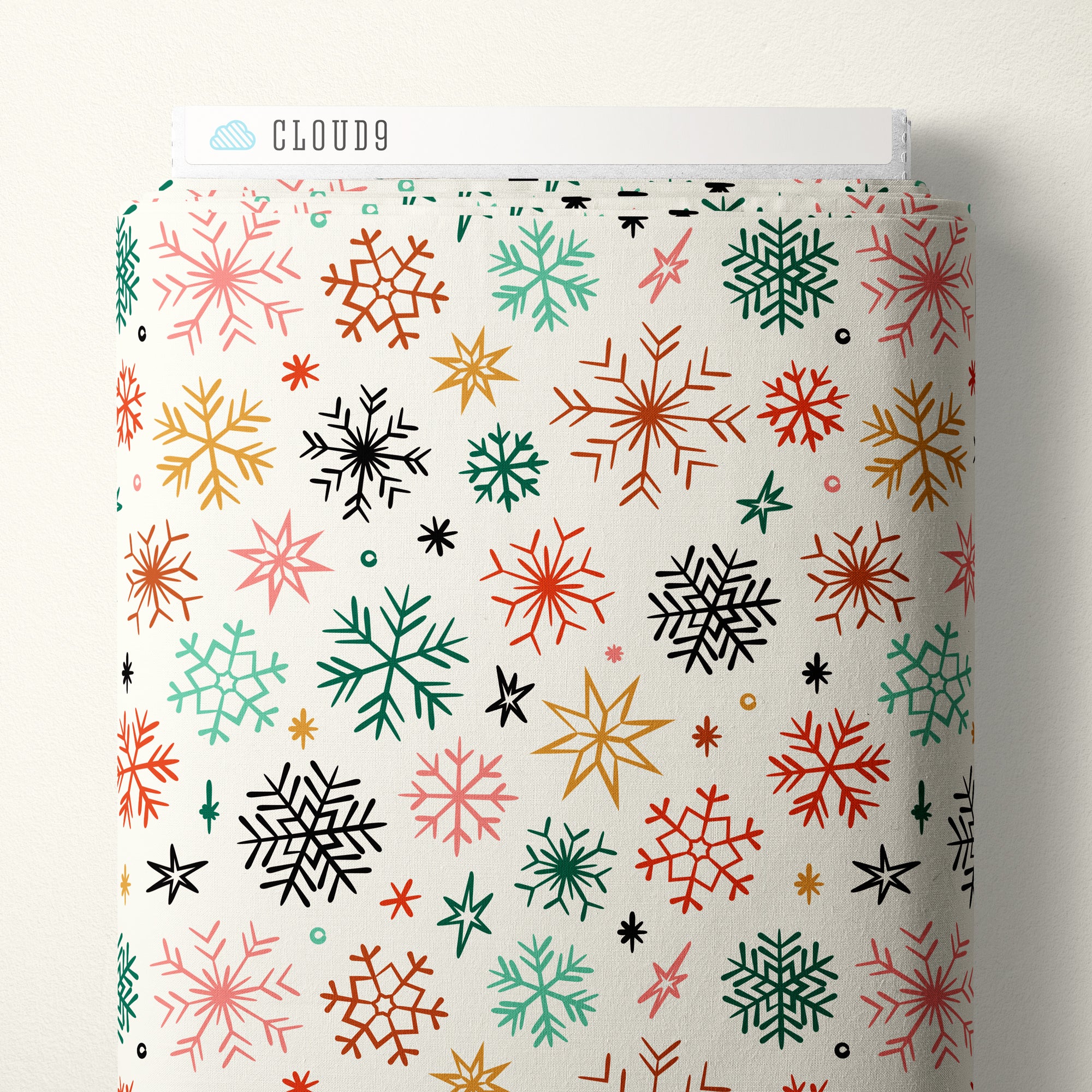 Patterned fabric with colorful snowflake design on a white background