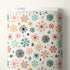 Patterned fabric with colorful snowflake design on a white background