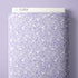 A roll of lavender purple fabric with a white line-art pattern of acorns and leaves, shown with a white header card labeled CLOUD9 at the top against a matching lavender background.
