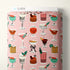 Fabric bolt with cocktail pattern on a pink background