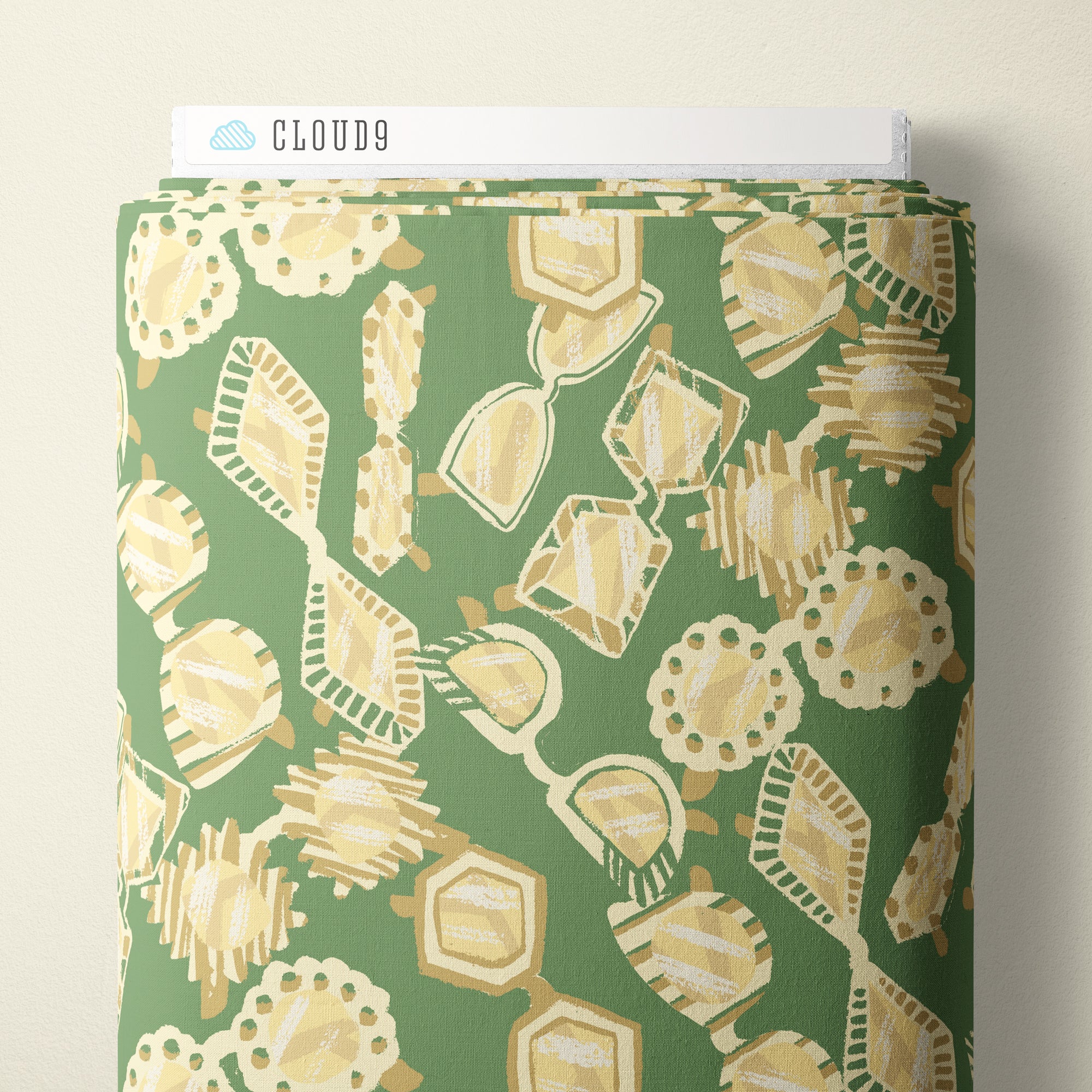 A roll of fabric with a green background and a beige and cream abstract geometric pattern, shown with a white header card labeled CLOUD9.