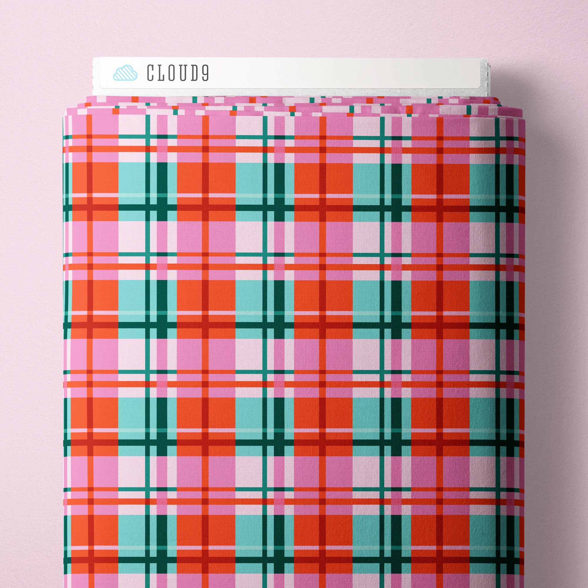 Plaid-patterned fabric bolt with 'Cloud9' branding on a pink background