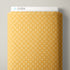 A roll of patterned fabric with a repeating geometric lattice design in mustard yellow and cream, shown with a white header card labeled CLOUD9.