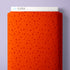 A roll of bright orange fabric with a repeating pattern of small red stars and dots, shown with a white label at the top reading CLOUD9 against a light lavender background.