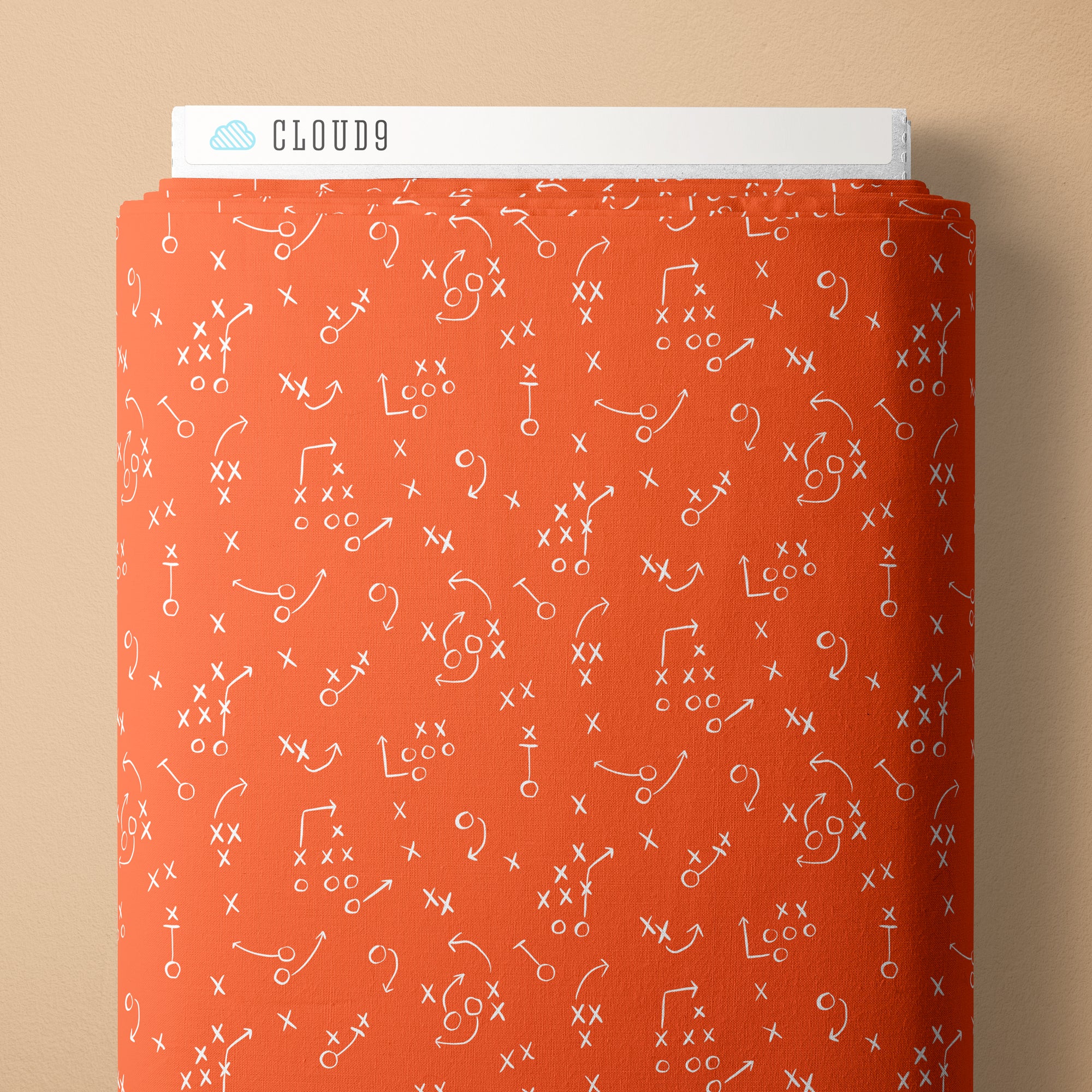 Fabric with white symbols on an orange cover against a beige background