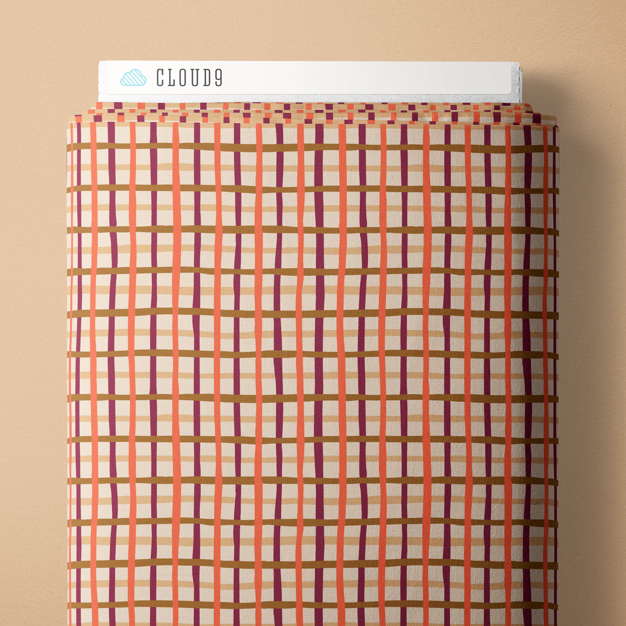 Plaid-patterned product with 'Cloud9' branding on a beige background