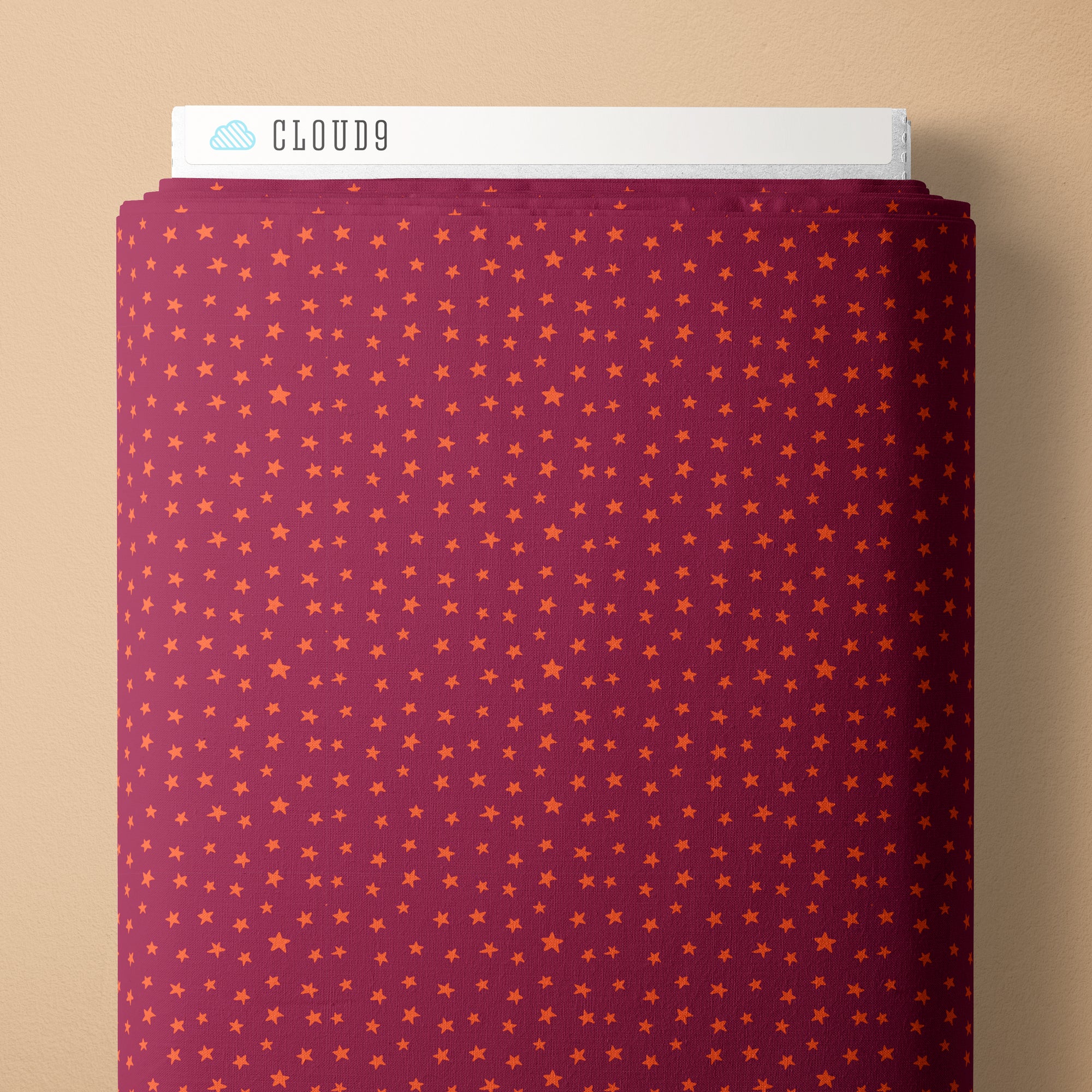 Folded fabric with star pattern on a beige background, branded 'Cloud9'.