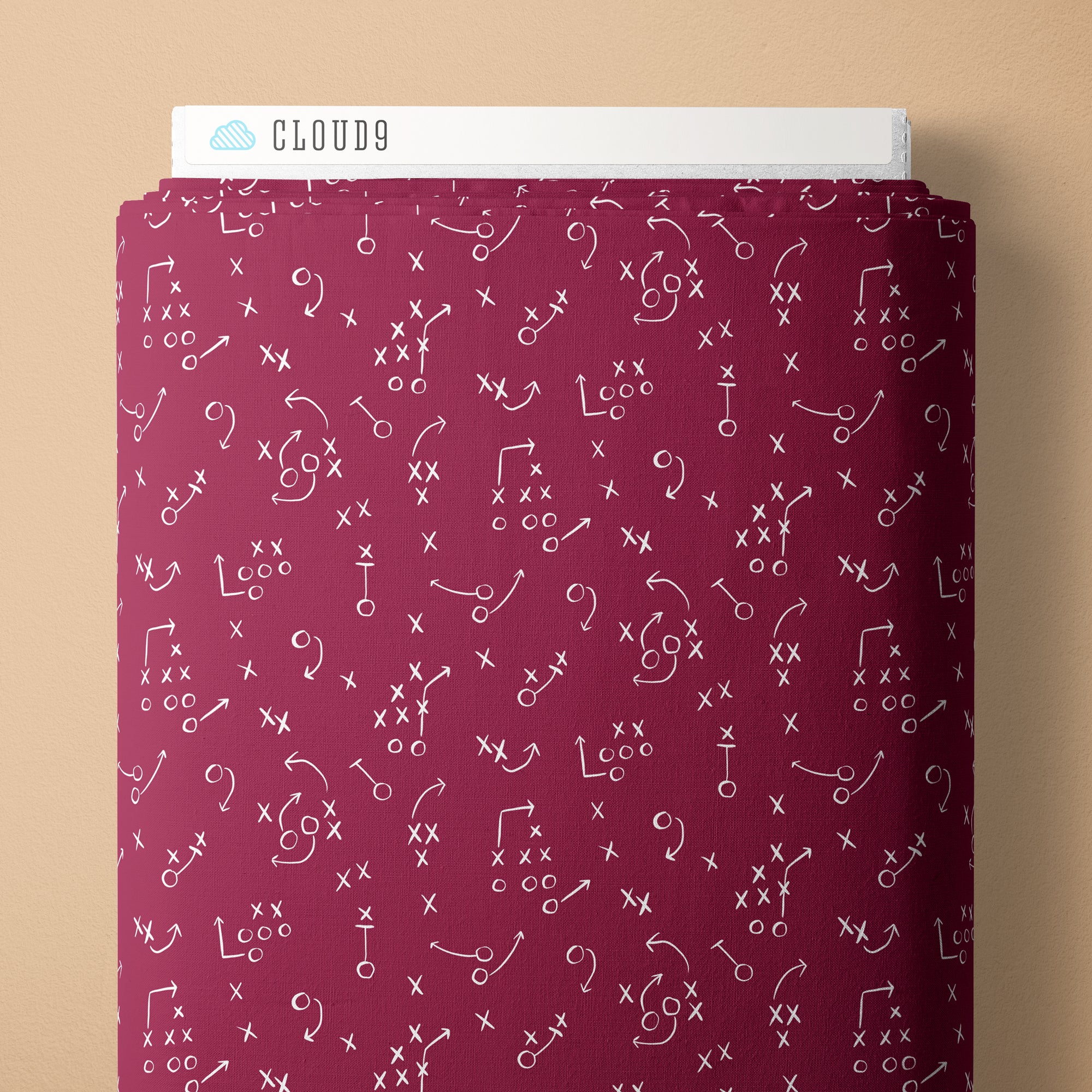 Maroon fabric with white symbols on a beige background