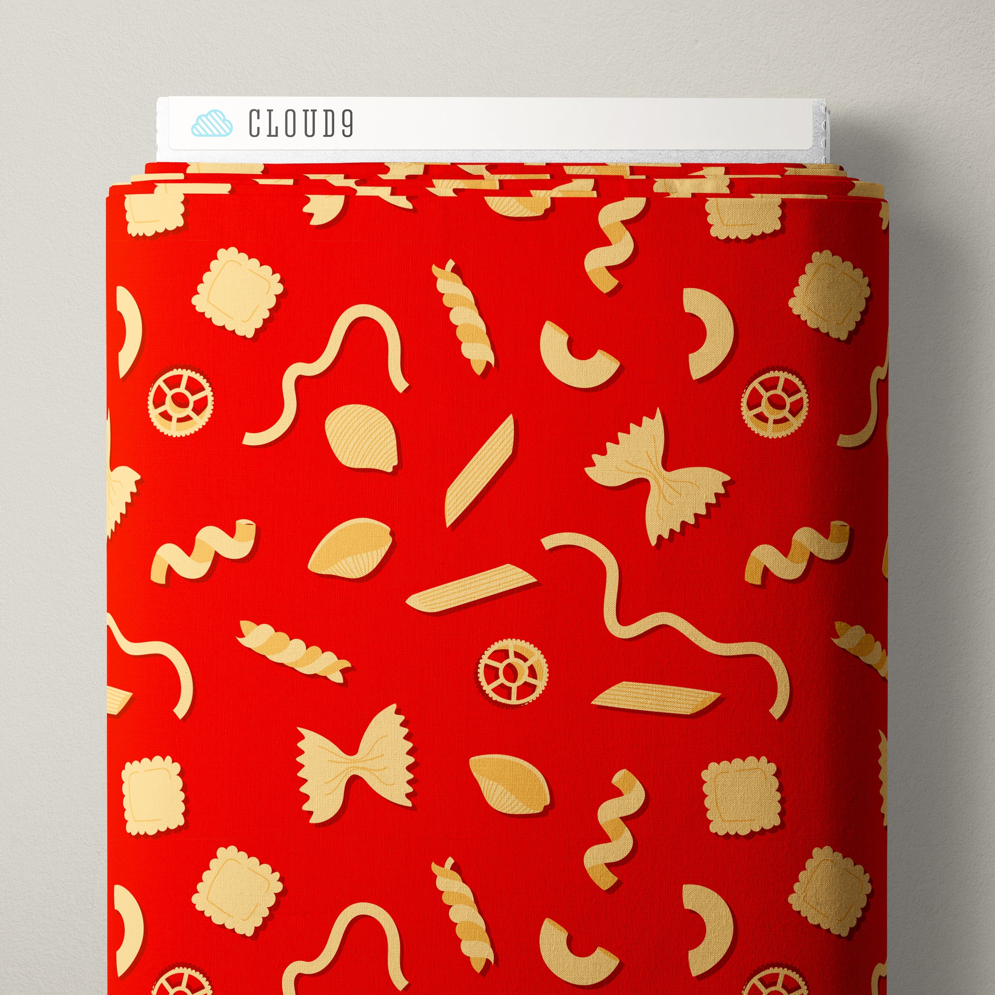 A roll of fabric featuring a vibrant red background with a playful pattern of flat-baked pasta shapes in a pale yellow/gold color. A white header card with the brand name 'CLOUD9' is visible at the top.