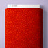 A close-up of a red patterned fabric or paper sheet with a white top edge labeled CLOUD9, shown against a pale lavender background.