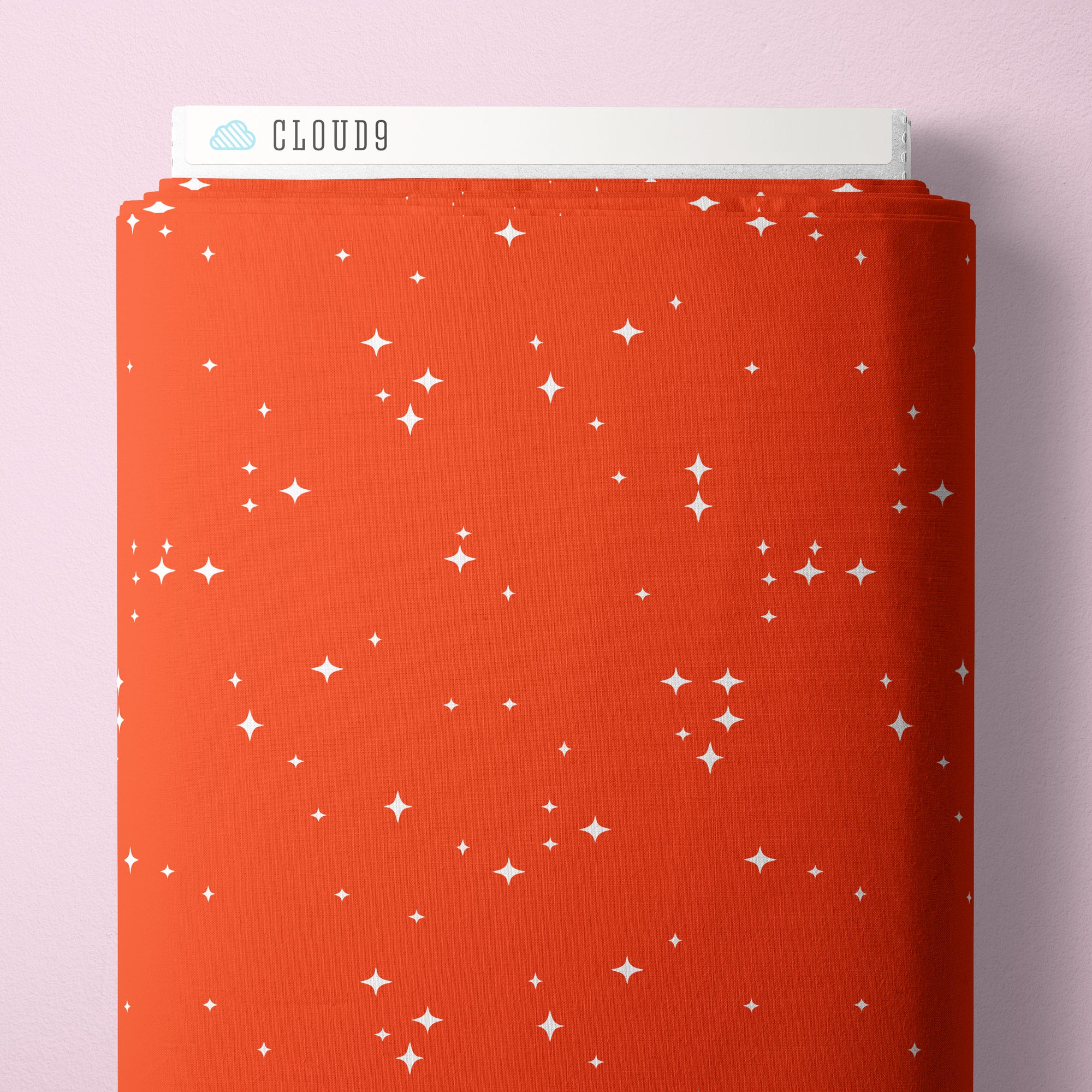 Red fabric bolt with white star pattern on a pink background, branded 'Cloud9'.