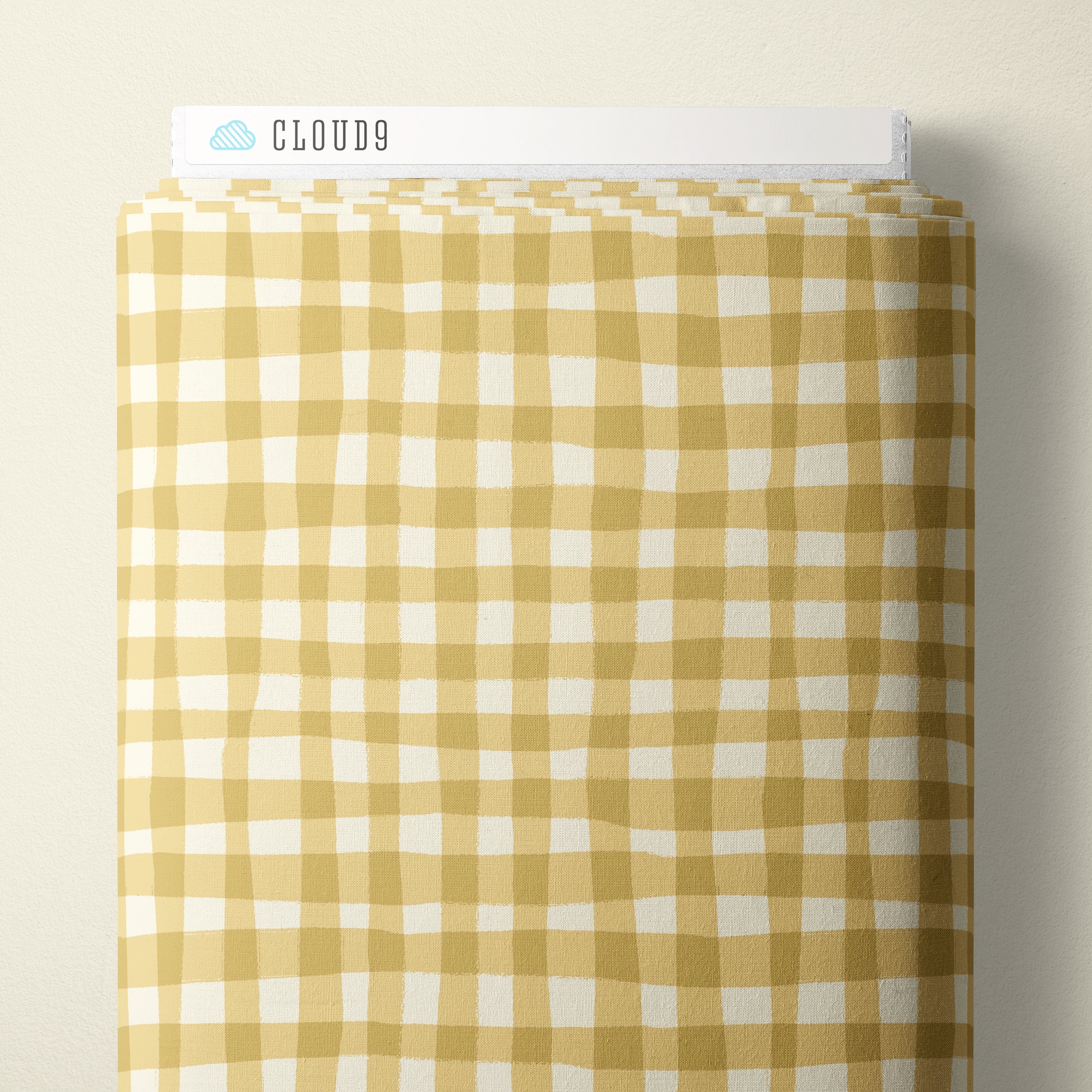 A bolt of fabric with a yellow and white gingham check pattern, displayed against a light beige background. A white header card at the top features the brand name 'CLOUD9' with a small blue cloud logo.